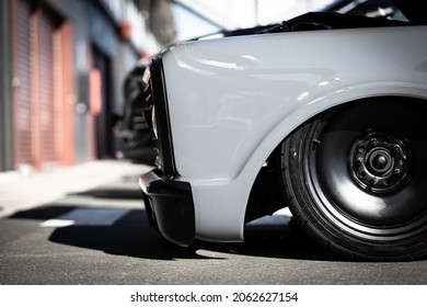 A lowered Ute parked in front of a garage door. Modified car. Car culture, automobile, vehicle, engine, cool car, grey car, drive.  - Shutterstock ID 2062627154