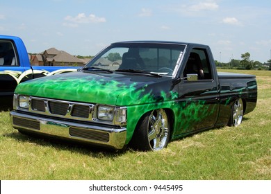 Lowrider Nissan Truck With Green Flames