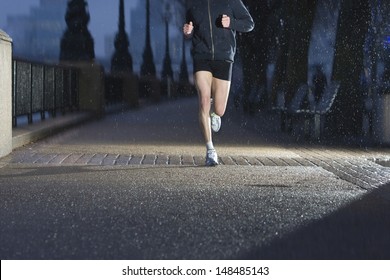 Lowsection of a man jogging on city pavement at dawn n London - Powered by Shutterstock