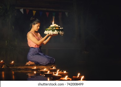 Loy Krathong Traditional Festival, Thai woman hold kratong, Thailand, Asia woman in Thai dress traditional hold kratong and bring Krathong to float in Loi kratong day of Thailand.