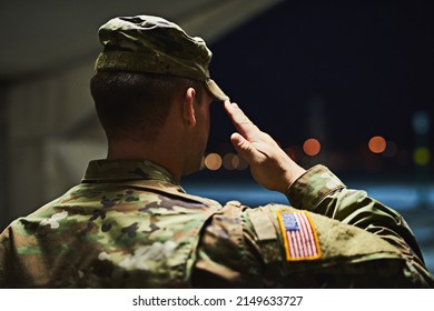 Loyal is the soldier who loves his country. Rearview shot of a young soldier standing at a military academy and saluting.