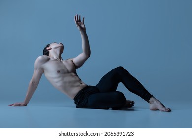 Loyalty, love and hope. Young and graceful man, male ballet dancer isolated on old navy studio background. Modern ballet, art, motion, action, inspiration concept. Natural beauty of male body - Powered by Shutterstock