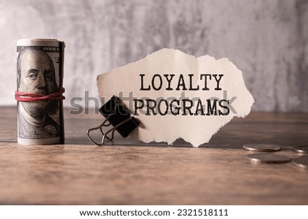 Loyalty Program text on a notepad on chart with keyboard and calculator.