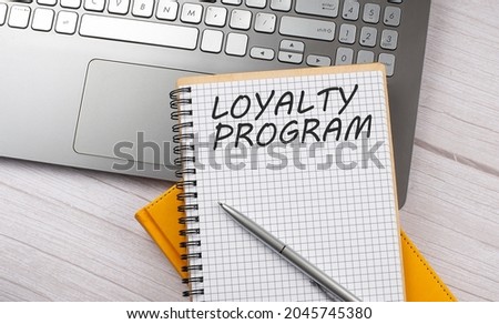 LOYALTY PROGRAM text written on notebook on the laptop