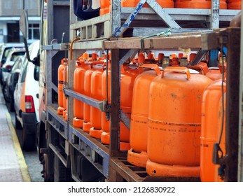 LPG cylinders. Orange bottles with butane.Truck delivered propane cylinders. Many gas tanks