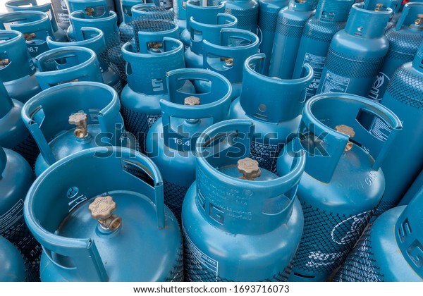 LPG gas\
bottle stack ready for sell, filling lpg gas bottle from the gas\
station in Lampang, Thailand - 18 July\
2018