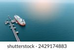 LPG ship, Oil tanker ship. Red Oil Tanker ranchored in Gas terminal gas tanks for storage. petroleum ship transportation import export fuel energy across red ocean sea. Vessel transport Gas 