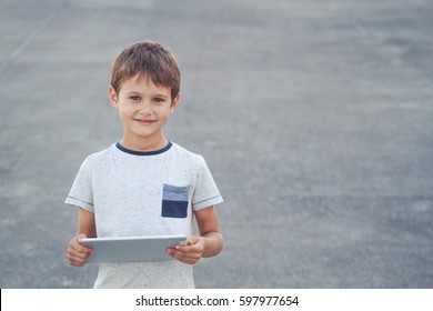 Lttle Kid With Tablet Computer. School, Education, Learning, Technology Leisure Concept