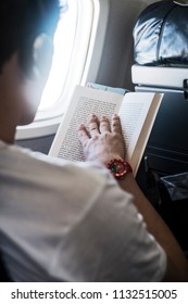LUANDA/ANGOLA - 17MAY2018 - Man reading book on airplane