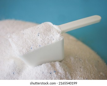 Luandry Washing Powder In White Plastic Scoop.