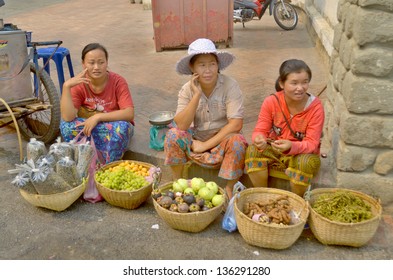 LUANG PRABANG LAOS MARCH 31: Woman Sells Fruit On The Street On March 31 2013 In Luang Prabang Laos. Laos Is One Of The Least Developed Countries In The World.