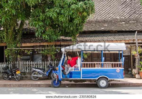 LUANG\
PRABANG, LAOS - MAY 12: Tuk-Tuk or mini van is  available all over\
town and easy way to get around. Mini van and mini bus can be hired\
through guesthouses and hotels on May 12,\
2014