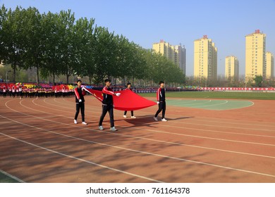 Luannan County - April 21, 2016: flag hand walking on the playground, Luannan County, Hebei Province, China