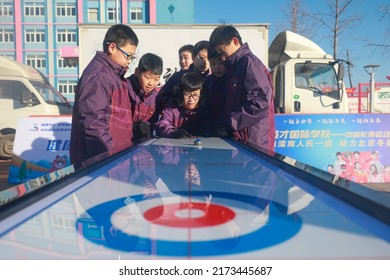 LUANNAN COUNTY, China - December 24, 2021: Middle School Students Are Experiencing Ice And Snow Sports -- Table Curling, North China.