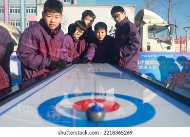 LUANNAN COUNTY, China - December 24, 2021: Middle School Students Are Experiencing Ice And Snow Sports -- Table Curling, North China.