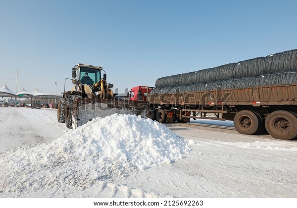 LUANNAN COUNTY, China\
- February 14, 2022: highway traffic managers drive forklifts to\
clear the snow on the highway and ensure that the highway is\
unblocked in North\
China