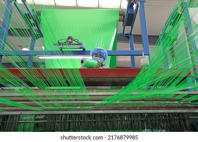 LUANNAN COUNTY, China - January 12, 2022: Workers Work Hard On The Plastic Fiber Textile Production Line, North China

