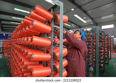 LUANNAN COUNTY, China - January 12, 2022: Workers Work Hard On The Plastic Fiber Textile Production Line, North China

