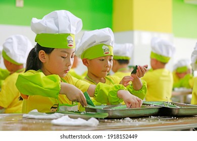 LUANNAN COUNTY, China - June 14, 2018: Children In Kindergarten Are Learning To Make Zongzi, LUANNAN COUNTY, Hebei Province, China