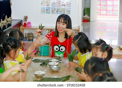 LUANNAN COUNTY, China - June 14, 2018: Children In Kindergarten Make Zongzi With Their Parents, LUANNAN COUNTY, Hebei Province, China