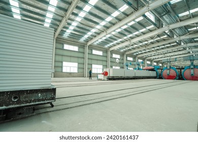 Luannan County, China - October 13, 2022: Workers manipulate machinery to pull new building materials partition boards out of the autoclave, Luannan County, Hebei Province, China