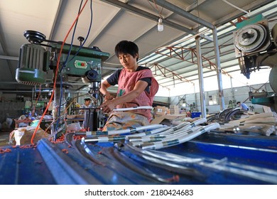 LUANNAN COUNTY, China - September 14, 2021: Workers Work Hard On The Sickle Processing Production Line, North China

