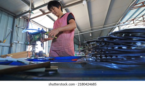 LUANNAN COUNTY, China - September 14, 2021: Workers Work Hard On The Sickle Processing Production Line, North China

