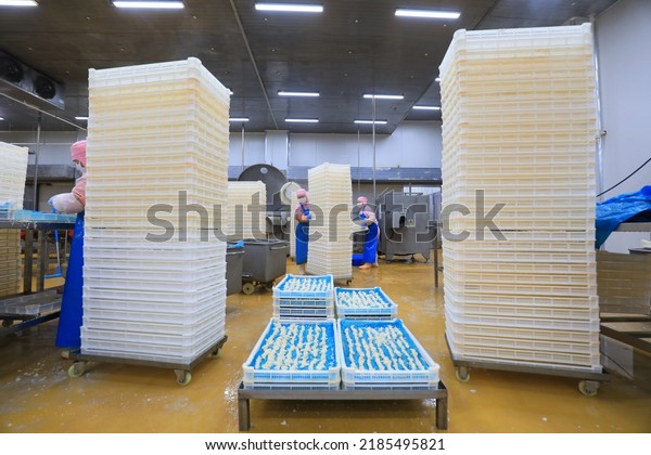 LUANNAN COUNTY, China - September 6,\
2021: workers process broiler food in a workshop,\
China