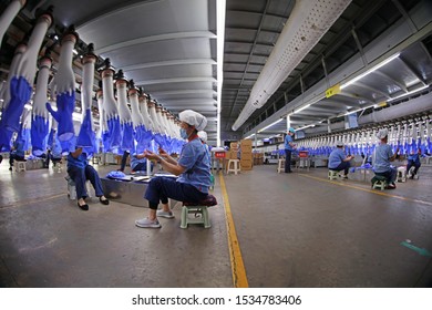 Luannan County - May 10, 2019: Workers Are Busy On The Nitrile-butadiene Glove Production Line In The Factory, Luannan County, Hebei Province, China.