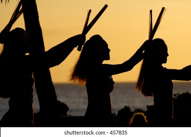 Luau Dancers Against A Sunset Sky On Oahu.