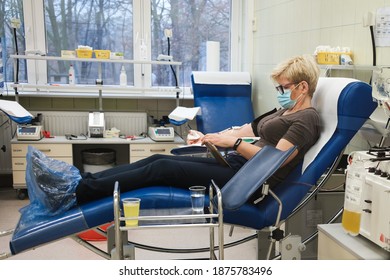 LUBIN, POLAND - DECEMBER 9, 2020. The Woman With Face Mask Donates Blood Plasma At The Donation Center. Plasma From Convalescents Is Used To Treat Patients With Covid-19 Disease.