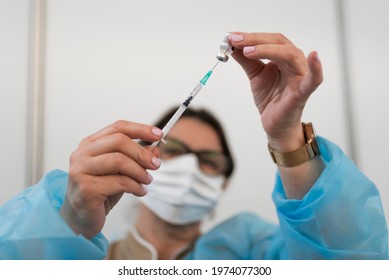 LUBIN, POLAND - MAY 11, 2021. Common Vaccination Point Against Covid-19. The Doctor Fills The Syringe With The Vaccine