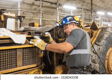 LUBIN, POLAND - OCTOBER 10, 2019 : Blue Color Worker Repairs Loading Machine In Copper Mine That Belongs To KGHM Polska Miedz.