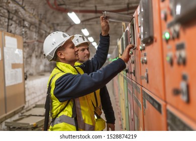 LUBIN, POLAND - OCTOBER 10, 2019 : Electricians servicing switchgear in copper mine that belongs to KGHM Polska Miedz.