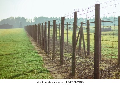 Lublin / Poland - 11.12.2018: grass and path between barbed wire fences in German concentration and extermination camp Majdanek. Lublin, Poland