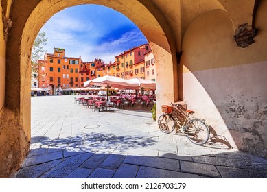 Lucca, Italy - View of Piazza dell'Anfiteatro square through the arch, ancient Roman Empire amphitheater, famous Tuscany. - Shutterstock ID 2126703179