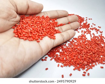 Lucent orange masterbatch granules isolated on white color background