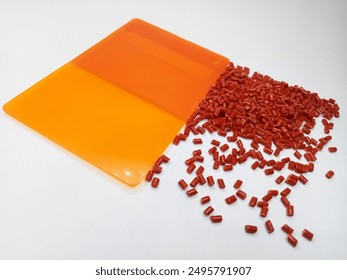 Lucent orange masterbatch granules isolated on white color background