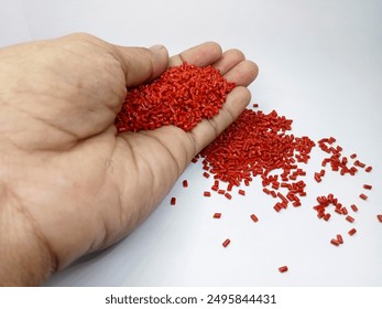Lucent orange masterbatch granules isolated on white color background