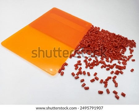 Lucent orange masterbatch granules isolated on white color background