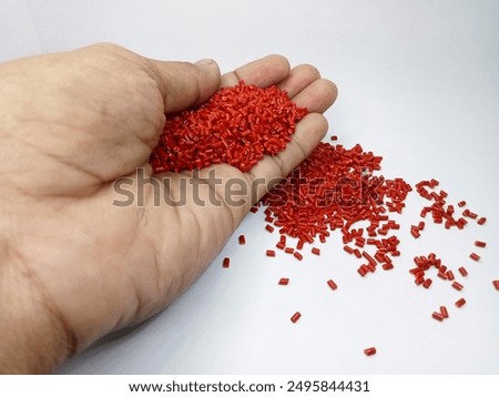 Lucent orange masterbatch granules isolated on white color background