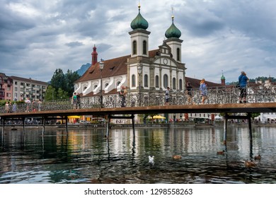 Lucerne, Switzerland  July 2018: Jesuit Church and buildings on waterfront of Reuss River