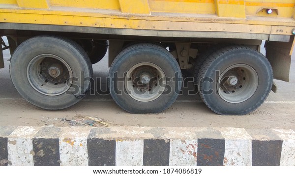Lucknow, India - December 13, 2020: Close up\
photo of big truck of transportation. Big truck tires with\
mechanical machinery.