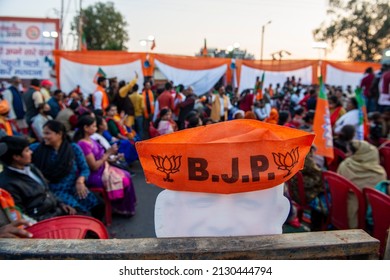 Lucknow, Uttar Pradesh, India, Feb 18 2022: A Bharatiya Janata Party Cap Kept On Cutout Of Chief Minister Yogi Adityanath. During BJP Rally In Lucknow City.