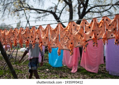 Lucknow, Uttar Pradesh, India- March 13  2013: Colorful Chikan Embroidery Clothes Drying On Clothesline Ropes In Broad Daylight At The Bank Of River Gomti At Lucknow City. 