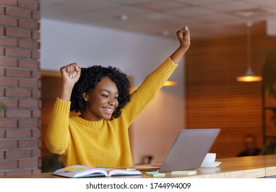 Lucky Day. Emotional Black Woman Looking At Laptop, Clenching Fists And Screaming, Working At Cafe, Copy Space