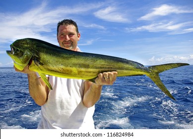 Lucky  fisherman holding a beautiful dolphin fish