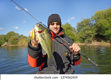 Lucky Fisherman Holding A Big Bass Fish. Freshwater Fishing, Lure Fishing, Boat Fishing