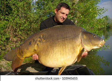 Lucky Fisherman Holding A Giant Mirror Carp