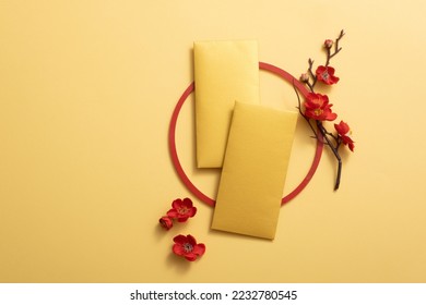 Lucky money is decorated with a red circle and red blossom. Chinese lunar new year background. Empty space for design. Chinese lucky items idea. - Powered by Shutterstock